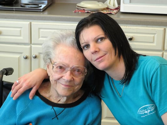 Resident and staff member smiling together