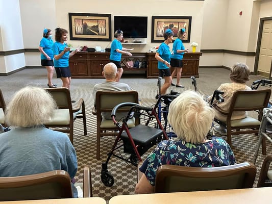 Residents enjoying a performance in a common area