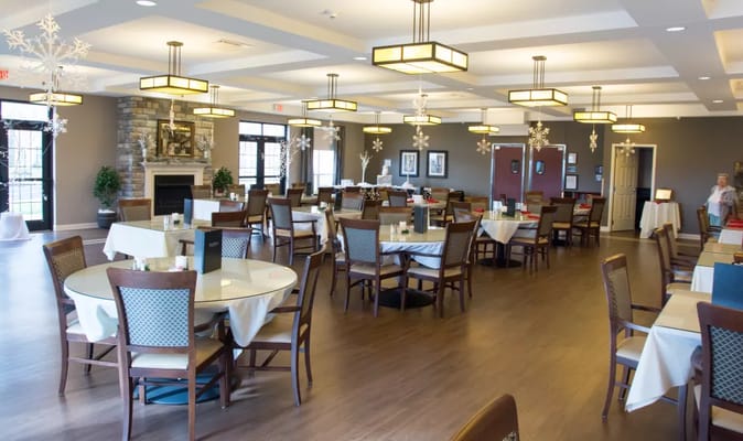 Bright dining room with tables set for meals