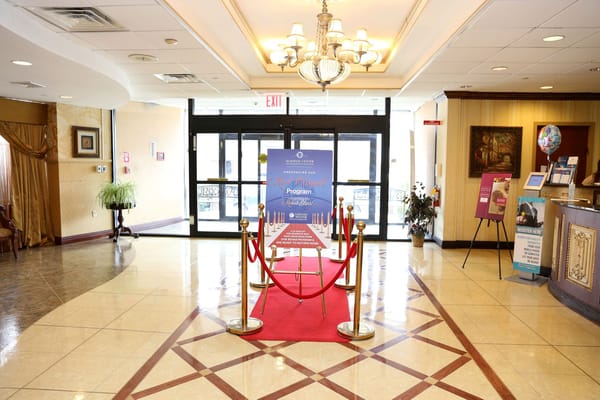 Interior lobby with red carpet and informational display