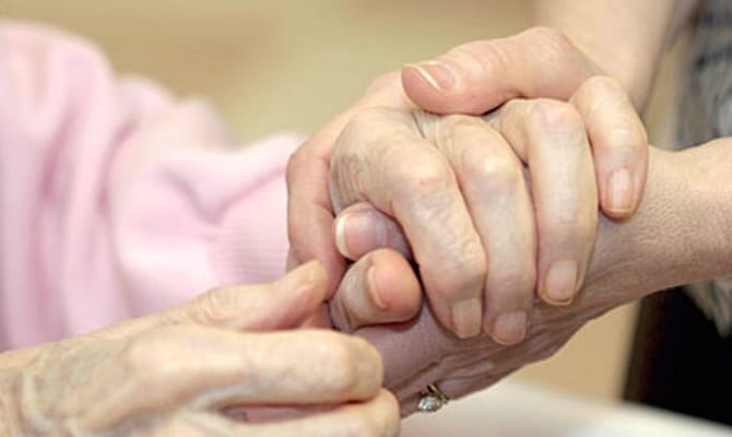 Two hands holding each other in a supportive gesture