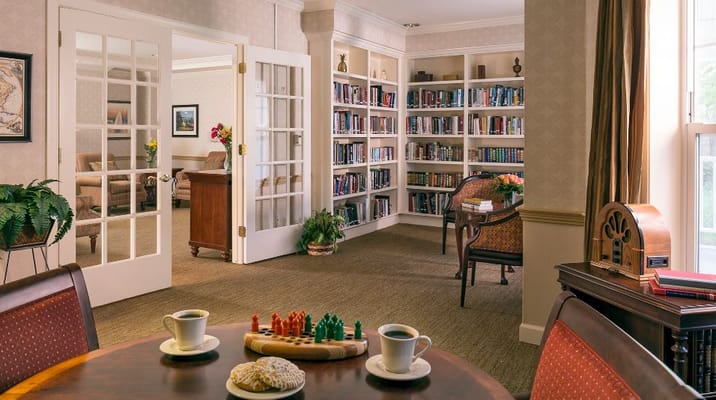 Cozy common area with bookshelves and coffee setup