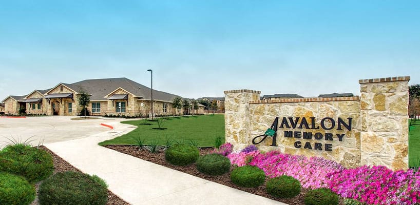 Exterior view of Avalon Memory Care facility with landscaping