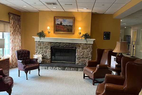 Cozy common area with stone fireplace and seating