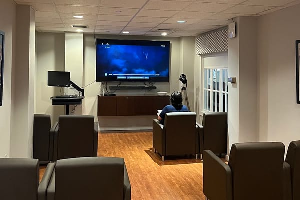 Resident watching a movie in a common area