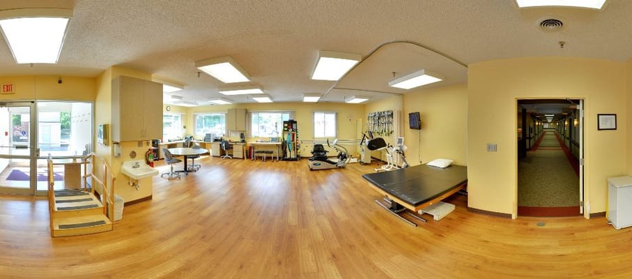 Therapy room with exercise equipment and bright lighting