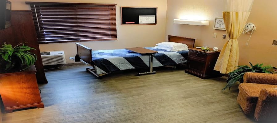 Interior view of a resident room with bed and furniture