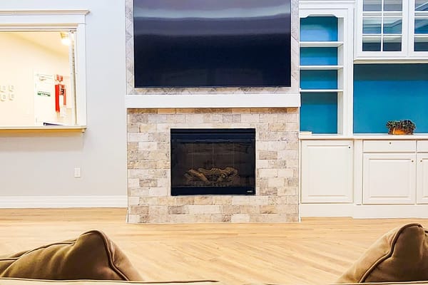 Cozy common area with a fireplace and TV