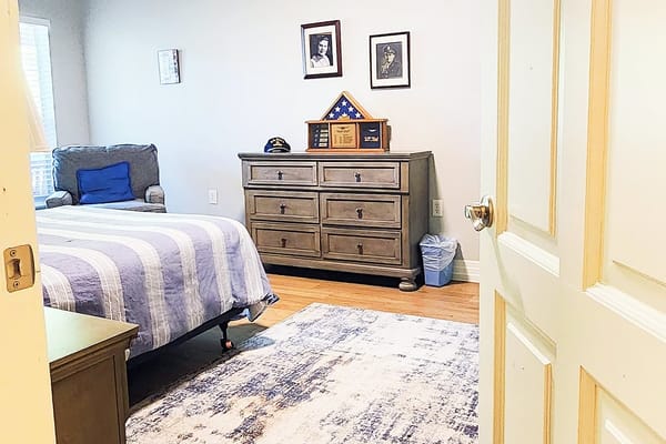 A cozy resident room with a bed and decor