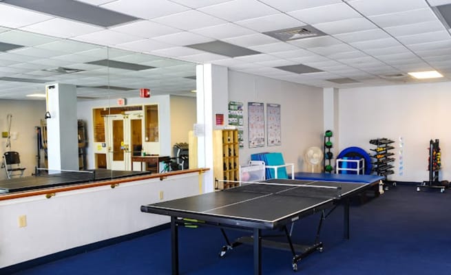Interior space with ping pong tables and gym equipment