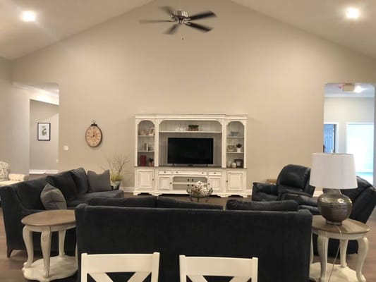 Bright common area with cozy seating and a television