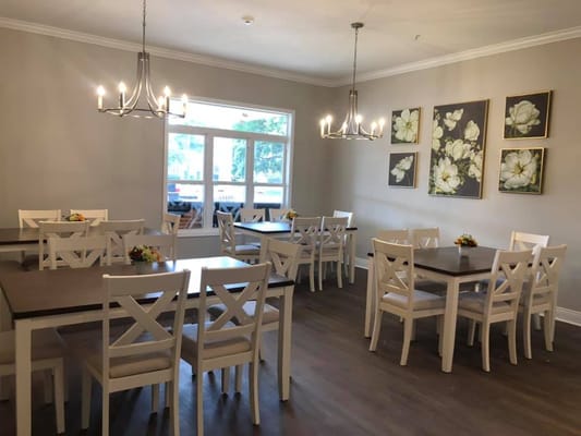 Bright dining room with tables and flowers
