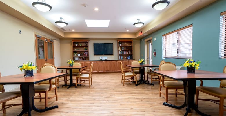 Bright common area with tables and flowers