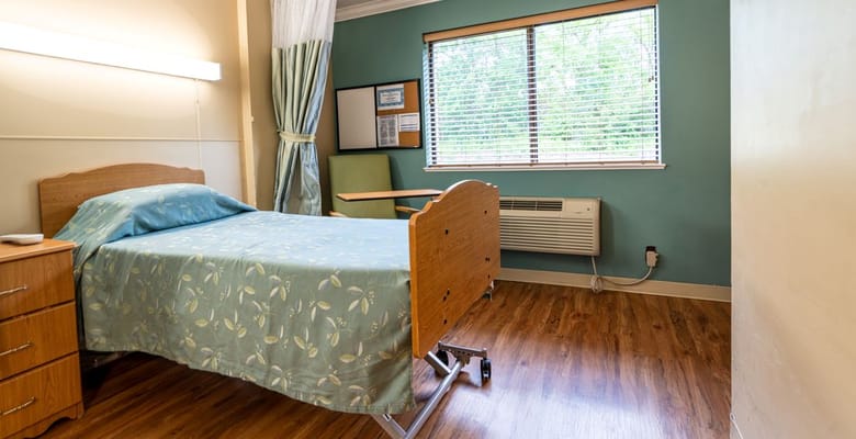 A well-furnished private resident room with a bed and window
