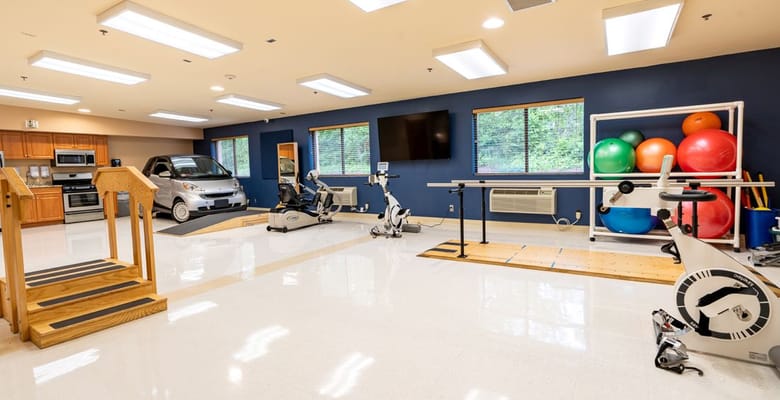Rehabilitation gym with exercise equipment and equipment storage