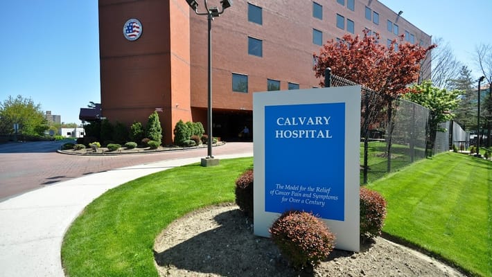 Exterior view of Calvary Hospital with landscaping