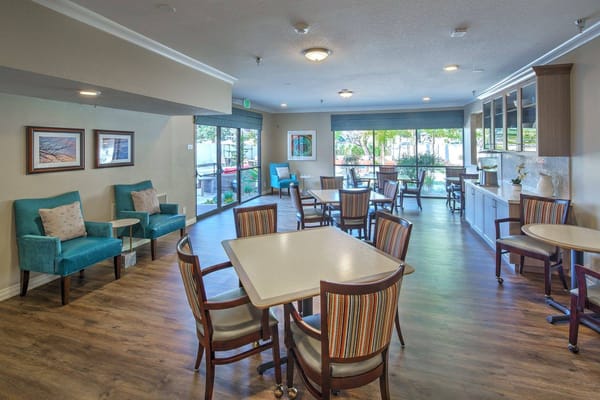 Bright common area with seating and large windows
