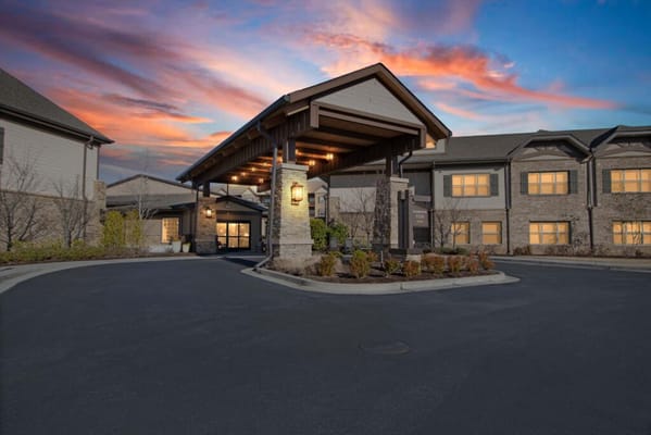 The entrance of a senior living facility at sunset