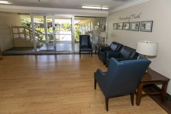 Lobby with seating area and large glass doors at Claremont Care Center