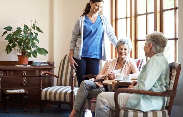 Staff member interacting with residents in a common area
