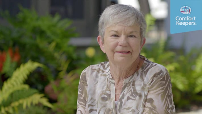Smiling resident in a garden setting