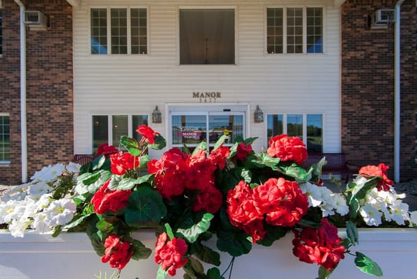 Exterior view of Countryside Manor with flowers in the foreground