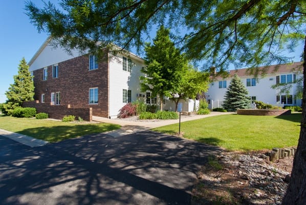 Sunny view of the building exterior and landscaped grounds