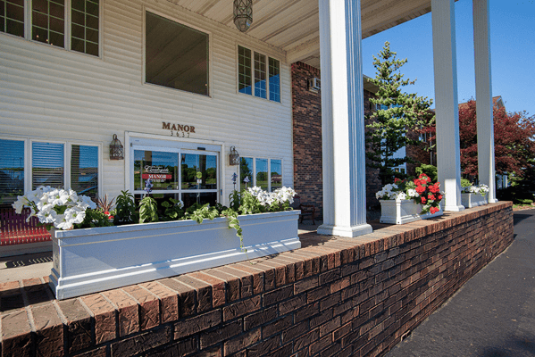 Exterior view of Countryside Manor with flowers and columns