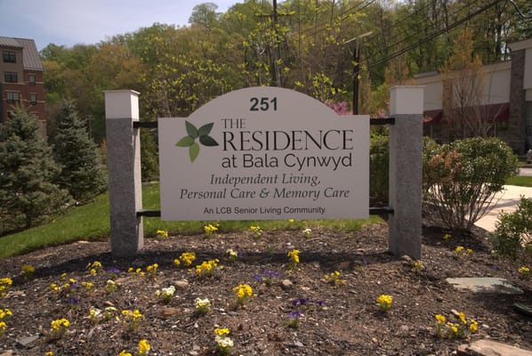 Sign of The Residence at Bala Cynwyd with flowers in front
