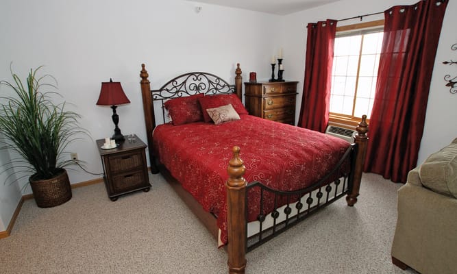 Cozy resident bedroom with red decor and furnishings
