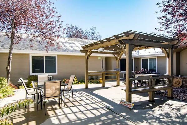 Outdoor seating area with shade structure and garden