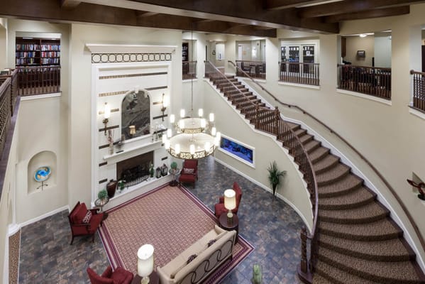 Interior view of a common area with a staircase and seating.