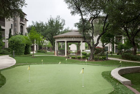 Outdoor area with a putting green and gazebo