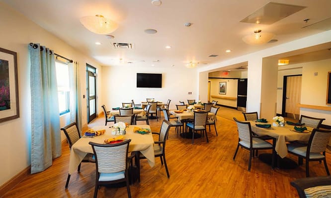 Dining room with tables set for residents
