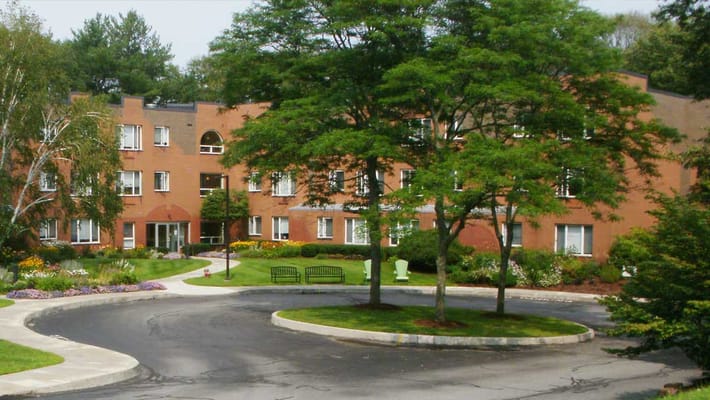 Exterior view of Fern Hill Apartments with garden and walkway