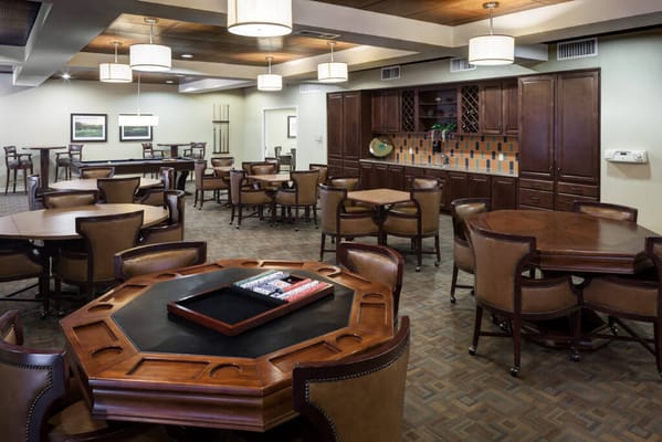 Common area with tables and chairs in a senior living facility