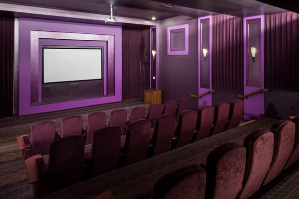 Interior view of a movie theater with purple decor