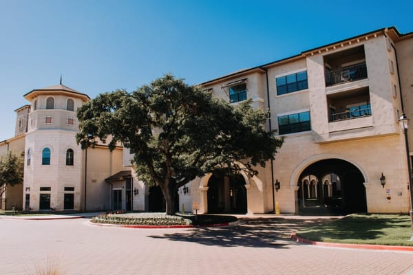 Exterior view of a senior living facility with landscaping