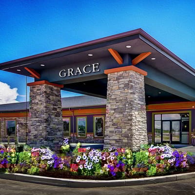 Entrance of Grace Assisted Living with colorful flower beds