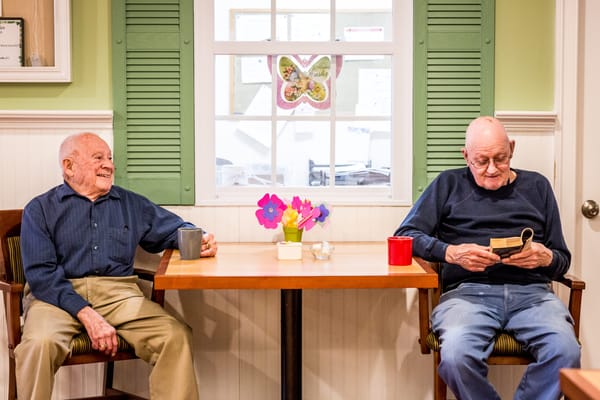 Two residents enjoying time together in a common area