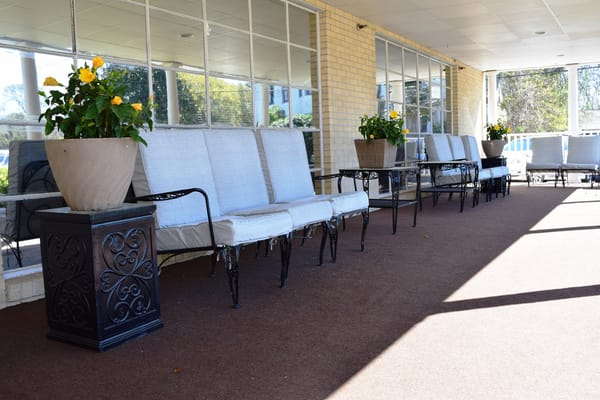 Outdoor seating area with potted flowers