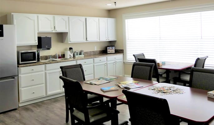 Kitchen area with dining tables and appliances