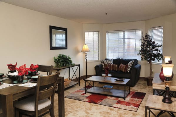 Living room with seating area and dining table at Heritage Oaks