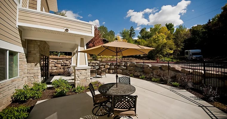 Patio area with table and umbrella outside the facility