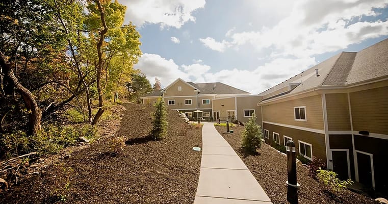 Pathway leading to an assisted living facility with landscaping