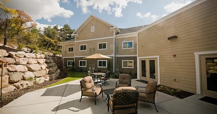 Outdoor patio area with seating and landscaping