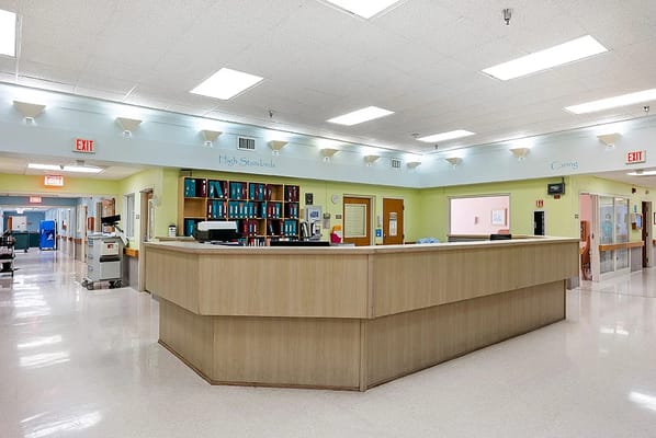 Warm and welcoming reception area with a desk and organizational shelves.