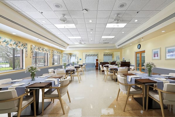Bright dining room with tables set for meals at Highlands Lake Center