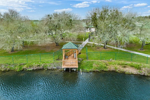 View of a wooden pavilion by the lake surrounded by trees