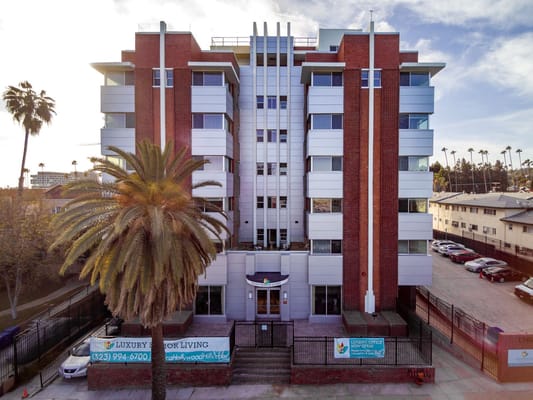 Exterior view of Hollywood Hills Senior Living with palm trees